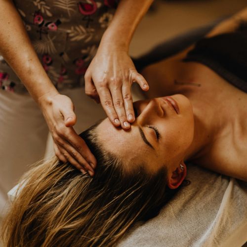 Practitioner gently touching head points during an Access Bars session